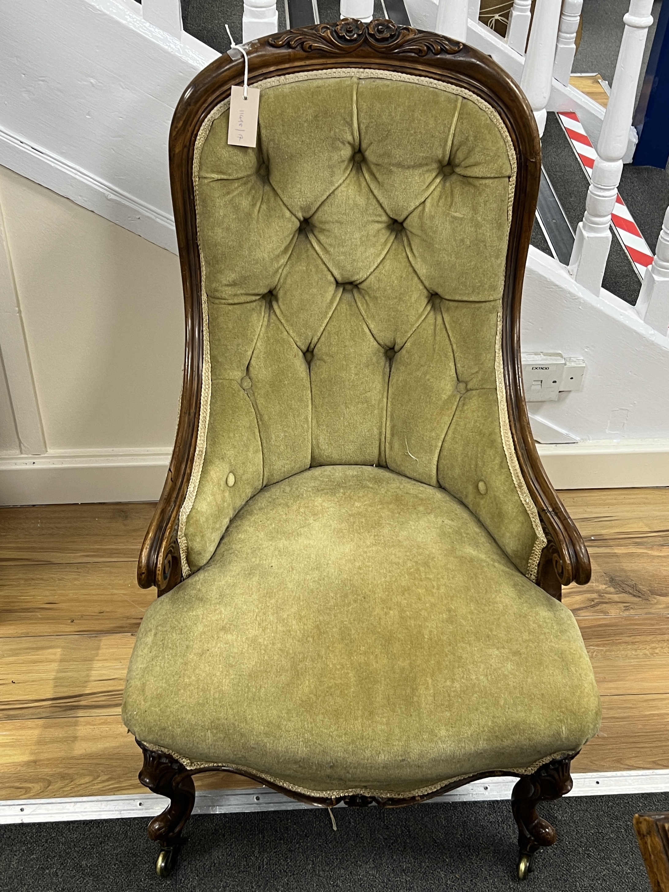 A Victorian carved walnut spoon back armchair, width 52cm, depth 66cm, height 91cm